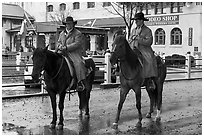 Cowboys in raincoats. Fort Worth, Texas, USA ( black and white)