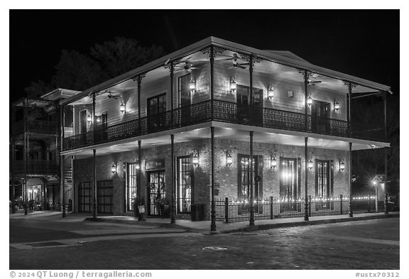 House with wrought iron balconies at night. Jefferson, Texas, USA (black and white)