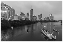 Skyline and tour boats on Colorado River at dusk. Austin, Texas, USA ( black and white)