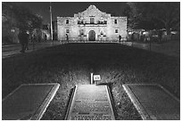 Commemorative signs and the Alamo at night. San Antonio, Texas, USA ( black and white)