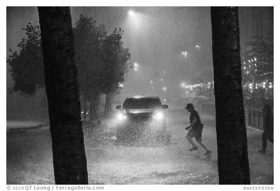 Pedestrian run in torrential rain at night. San Antonio, Texas, USA (black and white)