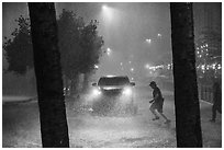 Pedestrian run in torrential rain at night. San Antonio, Texas, USA ( black and white)