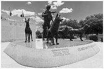 Granite pedestal with bronze statues, and history wall. Military Working Dog Teams National Monument. San Antonio, Texas, USA ( black and white)