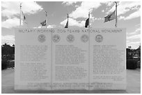 Granite wall with history incriptions, and the five US Armed Service flags, Military Working Dog Teams National Monument. San Antonio, Texas, USA ( black and white)