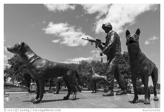 Sculpture of dog handler holding leash and M4 rifle with dogs, Military Working Dog Teams National Monument. San Antonio, Texas, USA (black and white)