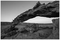 Slender and jagged Sunset Arch and the Straight Cliffs, sunrise. Grand Staircase Escalante National Monument, Utah, USA ( black and white)