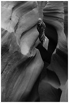 Man inside Peek-a-Boo slot canyon. Grand Staircase Escalante National Monument, Utah, USA ( black and white)