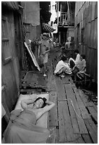 Sleeping late in a narrow alley. Ho Chi Minh City, Vietnam (black and white)