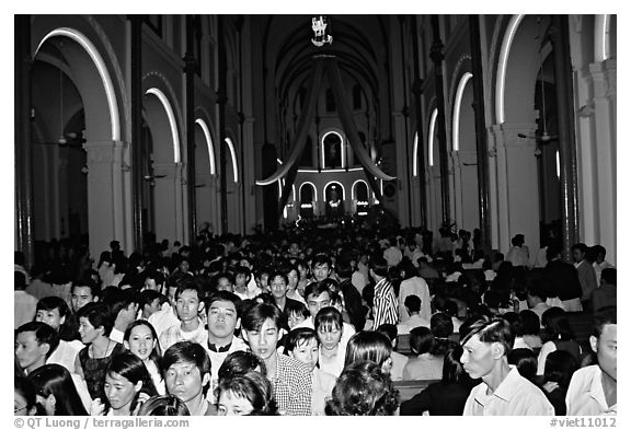 Crowds exit the Cathedral St Joseph at the end of the Christmas mass. Ho Chi Minh City, Vietnam