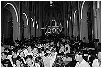Crowds exit the Cathedral St Joseph at the end of the Christmas mass. Ho Chi Minh City, Vietnam (black and white)