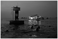 Lighted boat a dusk. Phu Quoc Island, Vietnam (black and white)