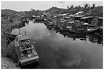 Fishing boats along dark river. Phu Quoc Island, Vietnam ( black and white)