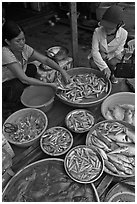 Customer purchasing fish at market, Duong Dong. Phu Quoc Island, Vietnam ( black and white)