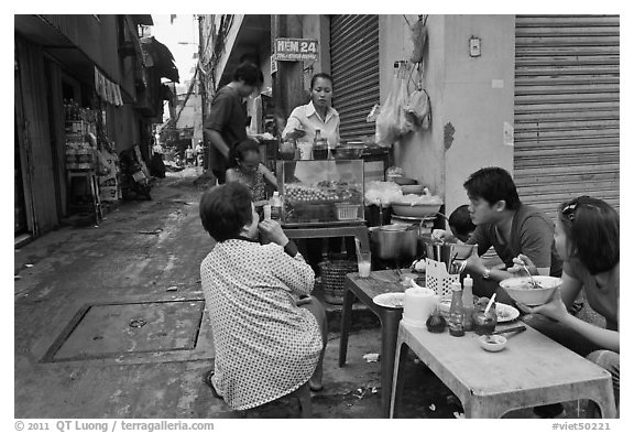 Breakfast at food stall in alley. Ho Chi Minh City, Vietnam