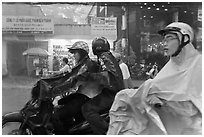 Motorcycle riders during afternoon mooson. Ho Chi Minh City, Vietnam ( black and white)