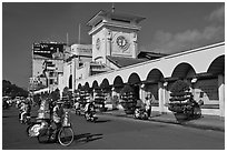Food vendor riding outside Ben Thanh Market. Ho Chi Minh City, Vietnam ( black and white)