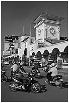 Chaotic motorcycle traffic outside Ben Thanh Market. Ho Chi Minh City, Vietnam (black and white)