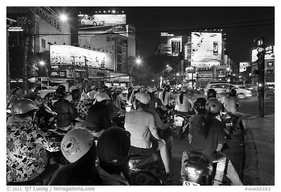 Motorbikes waiting at traffic light at night. Ho Chi Minh City, Vietnam (black and white)