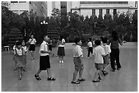 Children walking in circle in park. Ho Chi Minh City, Vietnam (black and white)