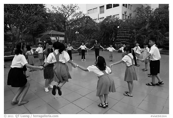 Children playing in circle in park. Ho Chi Minh City, Vietnam (black and white)