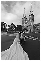 Bride with flowing dress in front of Cathedral. Ho Chi Minh City, Vietnam (black and white)