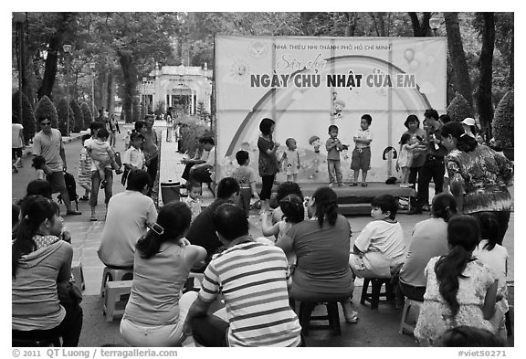 Children singing, Cong Vien Van Hoa Park. Ho Chi Minh City, Vietnam (black and white)