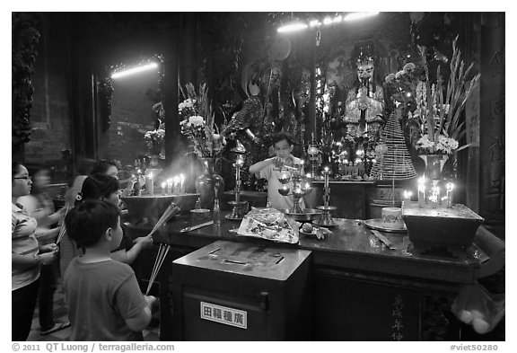 Man lightening candles, Jade Emperor Pagoda, district 3. Ho Chi Minh City, Vietnam (black and white)
