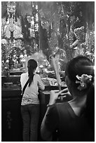 Women holding incense sticks, Phuoc Hai Tu pagoda, district 3. Ho Chi Minh City, Vietnam ( black and white)
