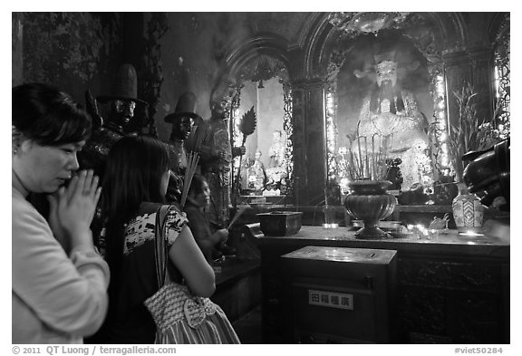 Women worshipping Thang Hoang, Phuoc Hai Tu pagoda, district 3. Ho Chi Minh City, Vietnam (black and white)