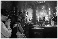 Women worshipping Thang Hoang, Phuoc Hai Tu pagoda, district 3. Ho Chi Minh City, Vietnam (black and white)