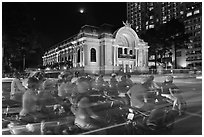 Motorcycles and Opera House at night. Ho Chi Minh City, Vietnam (black and white)