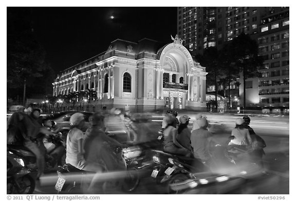 Motorbikes and colonial-area Opera House at night. Ho Chi Minh City, Vietnam (black and white)