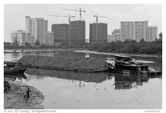River scene and high rise towers in construction, Phu My Hung, district 7. Ho Chi Minh City, Vietnam (black and white)