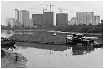 River scene and high rise towers in construction, Phu My Hung, district 7. Ho Chi Minh City, Vietnam (black and white)