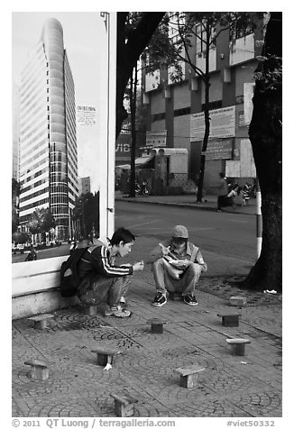 Men having breakfast on a sidewalk. Ho Chi Minh City, Vietnam (black and white)