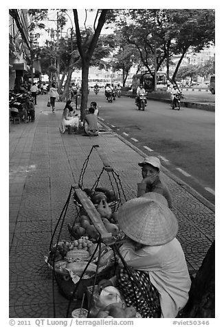 Women selling fruit on a large boulevard. Ho Chi Minh City, Vietnam (black and white)