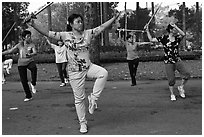 People practicisng Tai Chi with swords, Cong Vien Van Hoa Park. Ho Chi Minh City, Vietnam (black and white)