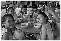 Girls sports team eating, Cong Vien Van Hoa Park. Ho Chi Minh City, Vietnam (black and white)