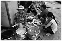 Woman offering soft tofu on the street. Ho Chi Minh City, Vietnam ( black and white)