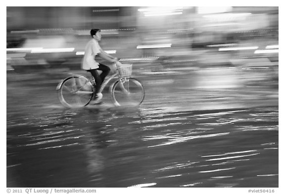 Night Bicyclist, water, and motion light streaks. Ho Chi Minh City, Vietnam (black and white)