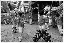 Dancers carry dragon on poles, Thien Hau Pagoda. Cholon, District 5, Ho Chi Minh City, Vietnam ( black and white)