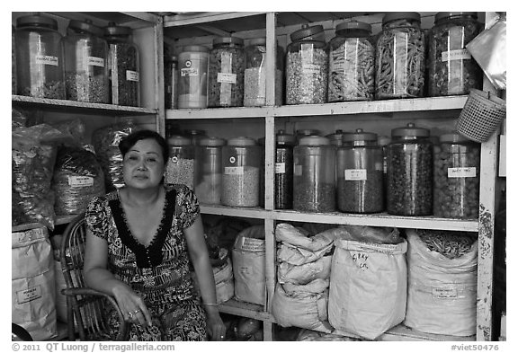Woman with jars of traditional medicinal supplies. Cholon, Ho Chi Minh City, Vietnam
