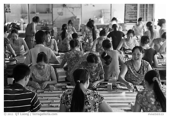 Women packing coconut candy in factory. Ben Tre, Vietnam