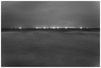South China Sea at night with lights of fishing boats on horizon. Mui Ne, Vietnam ( black and white)