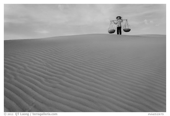 Woman on top of red sand dunes. Mui Ne, Vietnam (black and white)