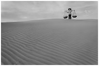 Woman on top of red sand dunes. Mui Ne, Vietnam ( black and white)