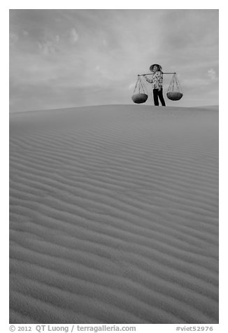 Woman on top of dune field. Mui Ne, Vietnam (black and white)