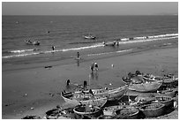 Boats and fishermen on beach. Mui Ne, Vietnam (black and white)