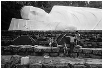 Pilgrims pitch tent below reclining Buddha statue. Ta Cu Mountain, Vietnam ( black and white)
