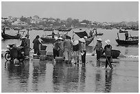 Fishing activity reflected on wet beach. Mui Ne, Vietnam ( black and white)